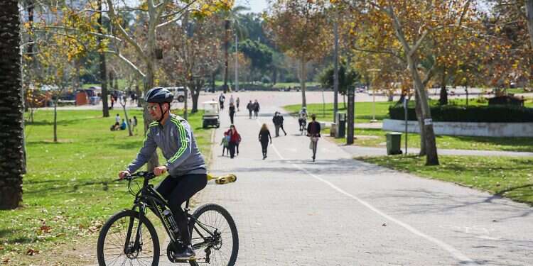 A man bikes through Yarkon Park in north Tel Aviv on February 28, 2021 Israeli bike NGO takes 'recycle' literally
