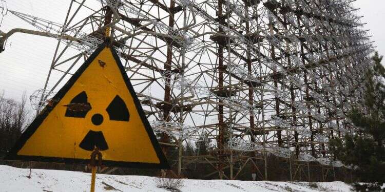 A top secret radar system once used as part of the Soviet missile defense early-warning radar network is seen behind a radioactivity sign in Chernobyl, Nov. 22, 2018 IAEA warns war putting Ukraine's nuclear power plants in 'unprecedented danger'