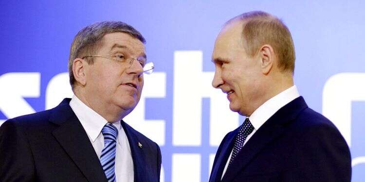 FILE - President Vladimir Putin, right, greets International Olympic Committee President Thomas Bach at an event welcoming IOC members ahead of the upcoming Winter Olympics at the Rus Hotel in Sochi, Russia, Feb. 4, 2014 Russia's Ukraine invasion tests Int'l Olympic Committee's claims of neutrality