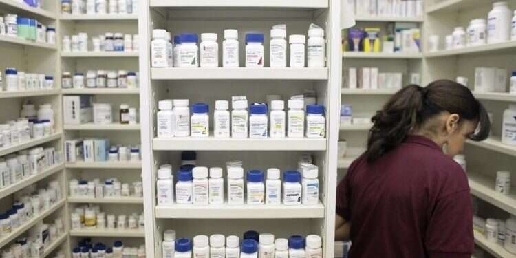 A pharmacy employee looks for medication as she works to fill a prescription while working at a pharmacy in New York, Dec. 23, 2009 Putin's nuclear comments lead to rush for iodine in Central Europe