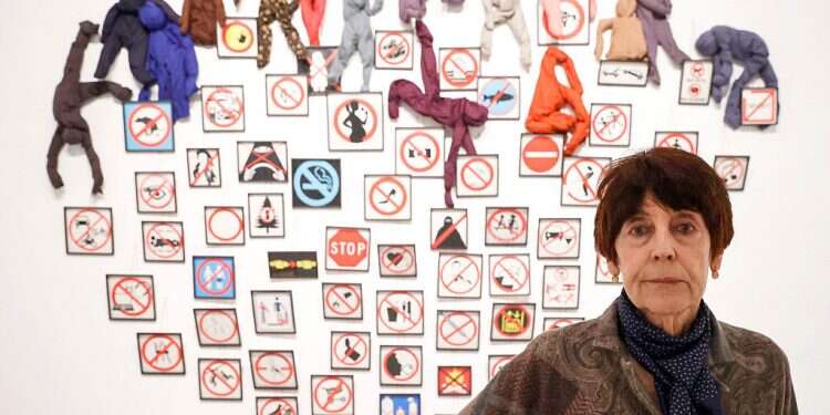 French artist Annette Messager poses by her art piece titled 'The interdictions in 2014' at the heart of a retrospective that is part of the 'Desires, Disorders' exhibition at the Tel Aviv Museum of Art on Feb. 28, 2022 French artist Annette Messager opens retrospective in Tel Aviv
