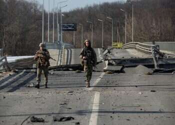 Ukrainian service members walk next to a destroyed bridge between the towns of Trostianets and Okhtyrka amid Russia's attack on Ukraine continues, in the Sumy region, Ukraine March 19, 2022
Ukrainian forces retake towns east of Kyiv, Britain reports