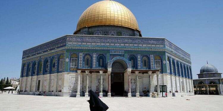 A woman walks past the Dome of the Rock in the Al-Aqsa Mosque compound in Jerusalem's Old City after Palestinians clashed with Israeli police on June 26, 2016 during the holy month of Ramadan
Jerusalem Hamas leader indicted following joint Shin Bet, Israel Police investigation