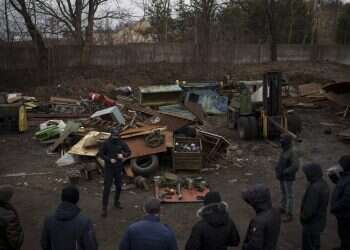 Roman, a former Ukrainian soldier injured in combat, gives instructions on how to handle weapons and move during conflict to civilians in the outskirts of Lviv on March 3, 2022 Kyiv auto repair shop adapts Russian weapons for Ukrainian fighters