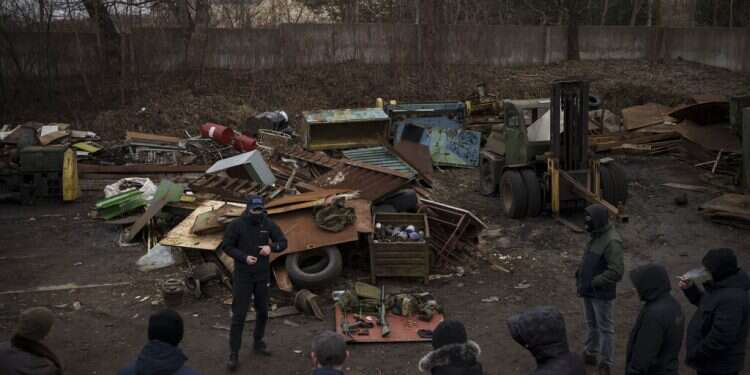 Roman, a former Ukrainian soldier injured in combat, gives instructions on how to handle weapons and move during conflict to civilians in the outskirts of Lviv on March 3, 2022 Kyiv auto repair shop adapts Russian weapons for Ukrainian fighters