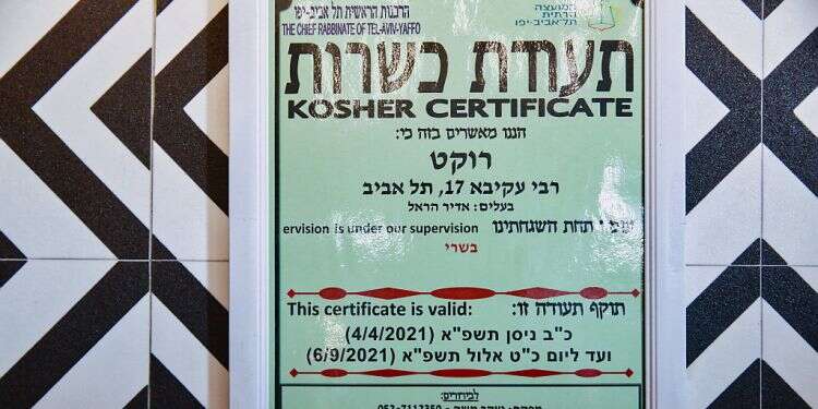 A kashrut certification is seen outside a Tel Aviv eatery, July 27, 2021 Chief Rabbinate to issue kashrut certifications online