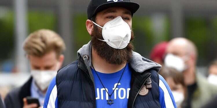 Hundreds of people keep a vigil at the synagogue in Gelsenkirchen, Germany, Friday, May 14, 2021 Germany says antisemitism far greater than official statistics