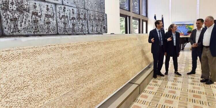 Israeli President Isaac Herzog views the largest matzah in Israel, at the President's Residence, April 10, 2022 Chew on this: Biggest matzah in Israel debuts in Jerusalem