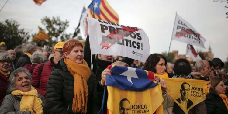 Demonstrators holding pictures of Catalan former regional Catalan cabinet member Jordi Turull protest outside at the Parliament of Catalonia in Barcelona, on Jan. 28, 2020 Catalan separatists seek lawsuit against Spanish gov't, NSO Group over hack