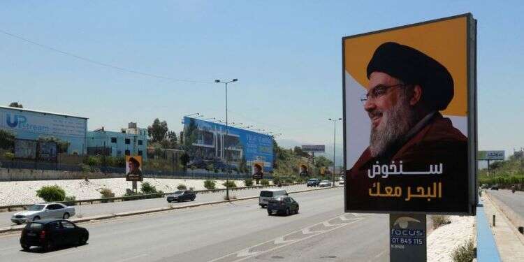 Vehicles drive past billboards depicting Lebanon's Hezbollah leader Hassan Nasrallah in Beirut, May 13, 2022 Nasrallah clings to 'victory' narrative despite blow Lebanon elections dealt Hezbollah