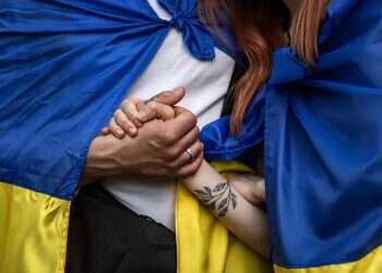 Demonstrators hold hands as they wear Ukrainian flags during a solidarity march with Ukraine on April 30, 2022 in Budapest, Hungary EU targets Russian oil as troops hit eastern Ukraine