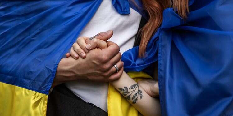 Demonstrators hold hands as they wear Ukrainian flags during a solidarity march with Ukraine on April 30, 2022 in Budapest, Hungary EU targets Russian oil as troops hit eastern Ukraine