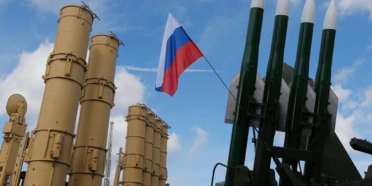 A Russian national flag waves between the S-300VM 'Antey-2500' and Buk Russian missile systems at the International Military-Technical Forum 'ARMY-2016' in the Russian Armed Forces 'Patriot' Park in Kubinka, Russia, Sept. 6, 2016 Did Moscow turn blind eye to transfer of Russian-made weapons to Hezbollah?