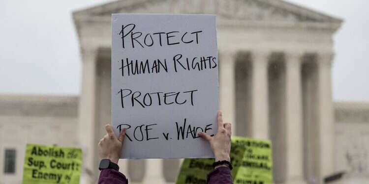 An abortion-rights protester holds up a sign during a demonstration in front of the US Supreme Court Building, May 7, 2022 in Washington, DC Jewish groups rally in Washington to 'fight for abortion rights'