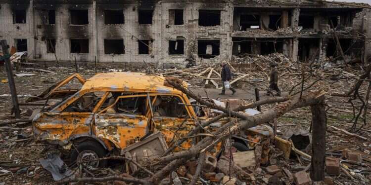 Men walk in a street destroyed by shellings in Chernihiv, Ukraine, April 13, 2022 1,500 people believed killed in Russian assault on Luhansk city