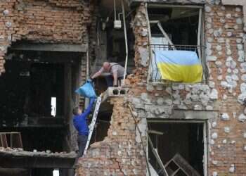 Residents take out their belongings from their house ruined by the Russian shelling in Irpin close to Kyiv, Ukraine, Saturday, May 21, 2022 Fate of Mariupol defenders uncertain; Ukraine proposes formal reparations deal