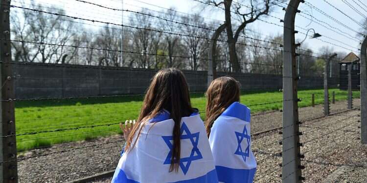 Israelis teen during the March of the Living at Auschwitz-Birkenau, in Oswiecim, southern Poland, April 16, 2015 Citing 'educative manipulations,' Israel cancels youth trips to Poland