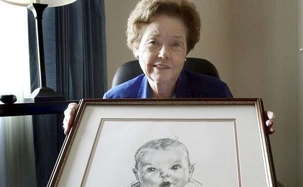 Ann Taylor Cook poses with a copy of her photo that is used on all Gerber baby food products, Feb. 4, 2004 Ann Turner Cook, original Gerber baby, dies at 95