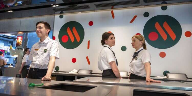 Staff members wait for visitors at a newly opened fast food restaurant in a former McDonald's outlet in Moscow, June 12, 2022 McDonald's restaurants in Russia reopen under new brand