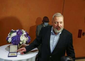 Nobel Peace Prize winner Dmitry Muratov, editor-in-chief of the influential Russian newspaper Novaya Gazeta, poses for a picture next to his 23-karat gold medal before it is auctioned at the Times Center, New York, June 20, 2022 Nobel sold for Ukrainian children breaks record