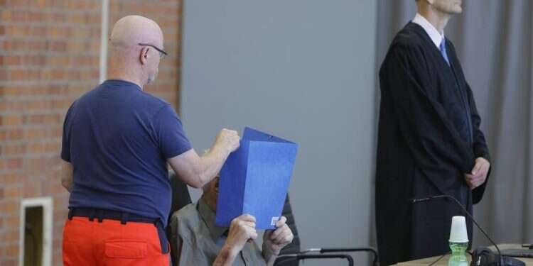 The accused Josef S. covers his face as he sits at the court room in Brandenburg, Germany, Tuesday, June 28, 2022 Germany: Former Nazi guard, 101, jailed for aiding murder