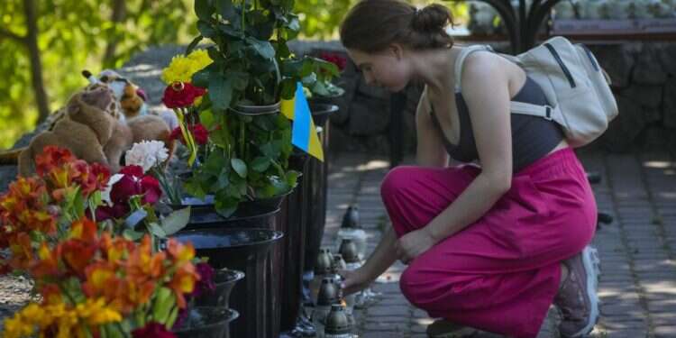 A woman lights a candle at a shopping center, after a rocket attack in Kremenchuk, Ukraine, June 28, 2022 Only a 'monster' would attack a mall, survivor of Kremenchuk strike says