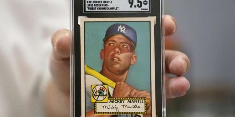 A Mickey Mantle baseball card is displayed at Heritage Auctions in Dallas, July 21, 2022 Rare 1952 Mickey Mantle baseball card going up for auction