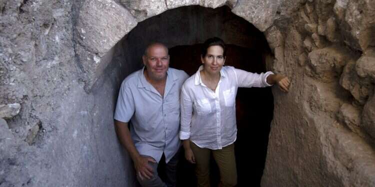 Hebrew University archaeologists Dr. Oren Gutfeld, left, and Michal Haber, pose at site of a Jewish ritual bath or mikveh, near the Western Wall in the Old City of Jerusalem on July 17, 2022
Elevator project takes archaeologists down through Old City's history