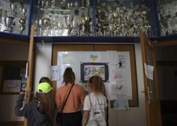 Ukrainian refugee children look at the drawings at the Lauder Morasha Jewish school in Warsaw, Poland, Thursday, July 28, 2022 Jewish volunteers bond with Ukrainian kids at summer camp