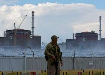 A Russian soldier stands guard near the Zaporizhzhia Nuclear Power Plant in Ukraine, Aug. 4, 2022 Ukraine's Zelenskyy rails at Russia's 'nuclear terror'