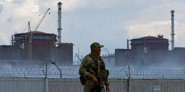 A Russian soldier stands guard near the Zaporizhzhia Nuclear Power Plant in Ukraine, Aug. 4, 2022 Ukraine's Zelenskyy rails at Russia's 'nuclear terror'