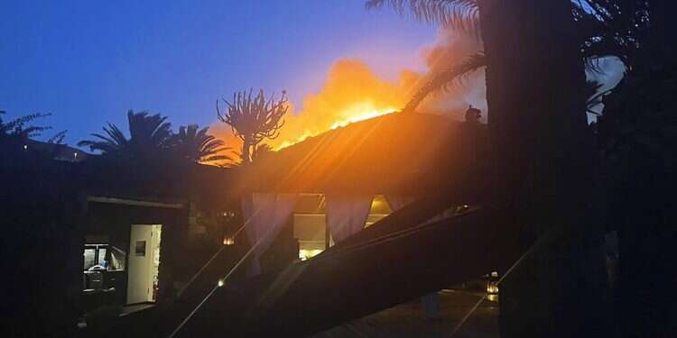 Flames burn beyond fashion designer Giorgio Armani's villa on the Sicilian island of Pantelleria, Aug. 17, 2022
Designer Giorgio Armani, guests flee wildfire on Sicilian island