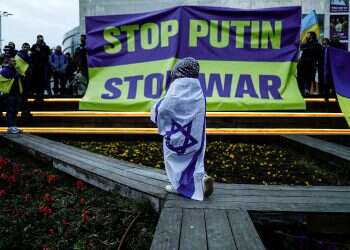 A child wrapped in an Israeli flag attends a demonstration in support of Ukraine in Tel Aviv, March 20, 2022 Grants offered to Jewish federations to resettle Ukrainian refugees