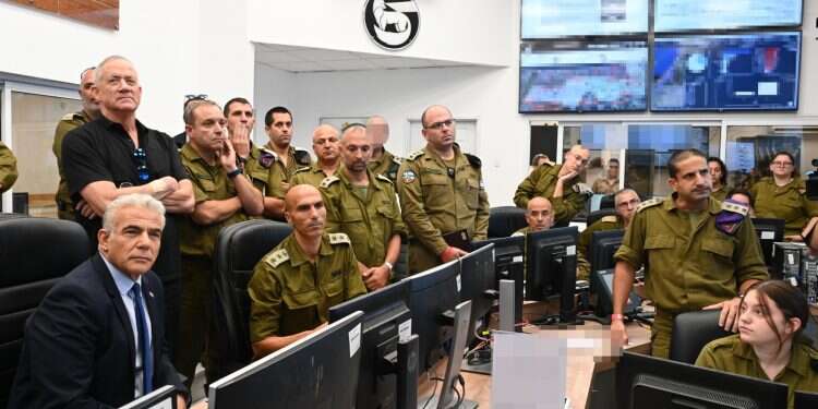 Prime Minister Yair Lapid with Defense Minister Benny Gantz visiting Southern Command on Sunday Southern Israel hit by massive rocket barrage as ceasefire talks intensify