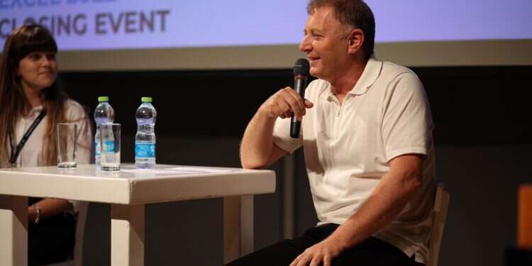 Ziv Aviram (right) speaks at the Taglit Excel event, alongside one of the fellowship graduates