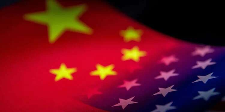 The flags of China and the United States are seen printed on paper in this illustration taken January 27, 2022 Chinese military says monitoring US Navy in Taiwan Strait