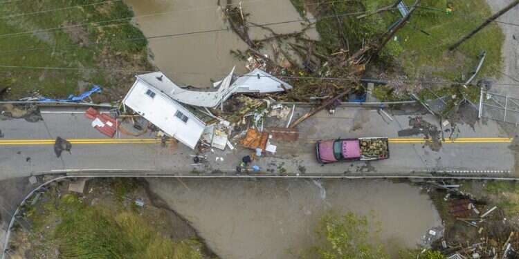 People work to clear a house from a bridge near the Whitesburg Recycling Center in Letcher County, Ky., on Friday, July 29, 2022 Local Chabad offers aid to Kentucky flood victims