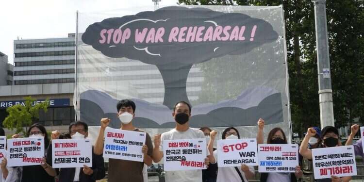 Protesters stage a rally to oppose the joint military exercises between the US and South Korea in front of the presidential office in Seoul, South Korea, Aug. 22, 2022 US, S. Korea open largest military drills in years