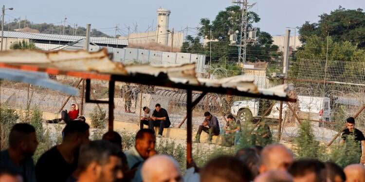 Palestinian laborers strike over plan to pay wages through PA banks