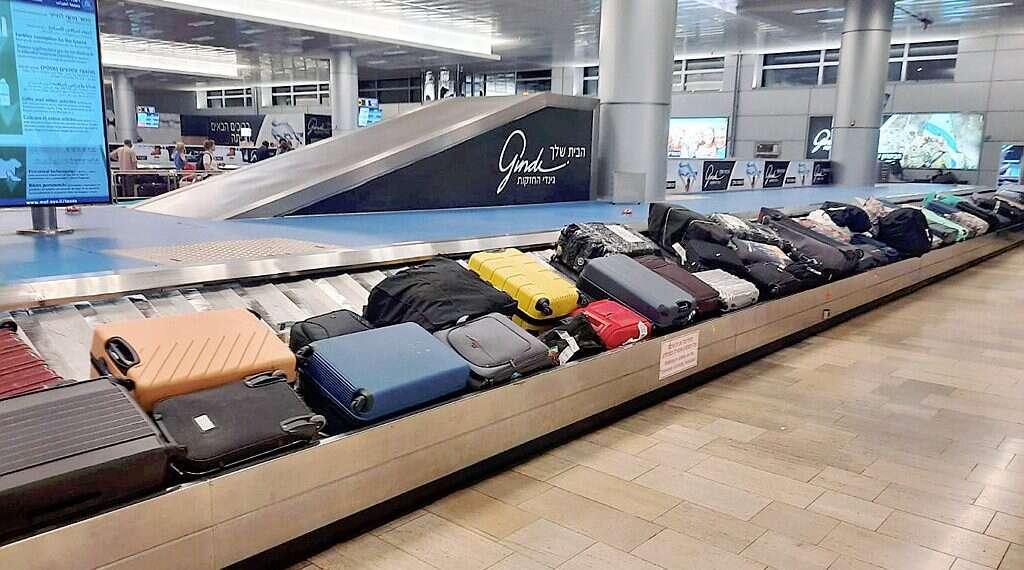 Luggage is seen on a carousel at Ben-Gurion International Airport on June 27, 2022 (illustrative) Ben-Gurion Airport luggage backlog leads police to suitcase full of drugs