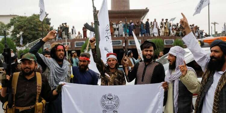 Taliban fighters hold Islamic Emirate of Afghanistan flags on the first anniversary of the fall of Kabul on a street in Kabul, Afghanistan, Aug. 15, 2022 US sticks to talks on releasing billions of Afghan assets despite Taliban dawdling