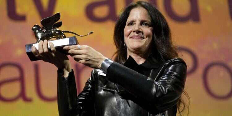 Director Laura Poitras holds the Golden Lion award for best film for 'All the Beauty and the Bloodshed' Poitras documentary wins top prize at Venice Film Festival