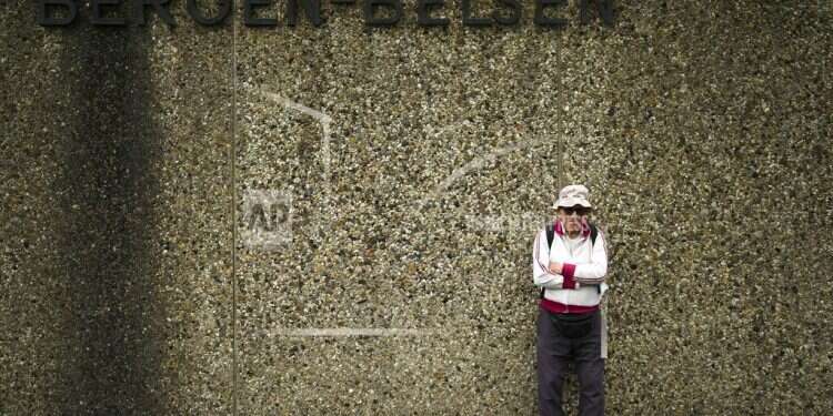 Israeli Olympic race walker Shaul Ladany poses for a photo at the entrance of the Nazi concentration camp Bergen-Belsen in Bergen, Germany, Sept. 3, 2022 Survivor of Holocaust, Munich attack heads back to Germany