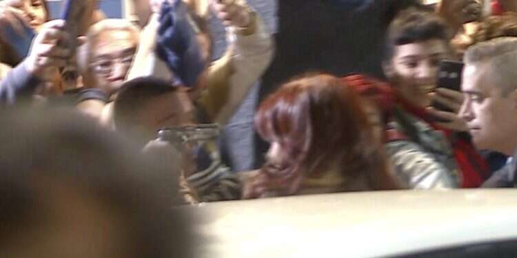 This still image taken from a video provided by Television Publica Argentina shows a man pointing a gun at Argentina´s Vice President Cristina Fernandez during an event in front of her home in the Recoleta neighborhood of Buenos Aires, Argentina, Sept. 1, 2022 Argentina's VP unharmed after failed assassination attempt