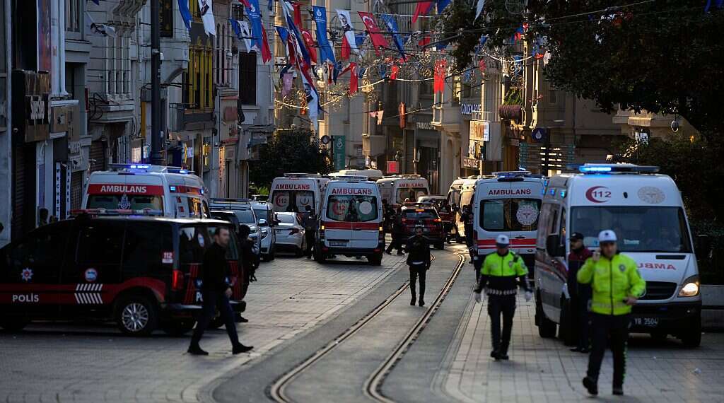 Police vehicles and ambulances are parked at the site of an explosion on Istanbul's popular pedestrian Istiklal Avenue in Istanbul, Turkey, Sunday, Nov. 13, 2022. Istanbul Gov. Ali Yerlikaya tweeted that the explosion occurred at about 4:20 p.m. (1320 GMT) and that there were deaths and injuries, but he did not say how many Erdogan vows punishment after 'heinous attack' kills 6 in Istanbul, injures 50