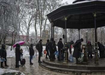 People wait in line to collect water, in Kyiv, Ukraine, Nov. 24, 2022 Kyiv flips to survival mode after missiles leave capital without electricity