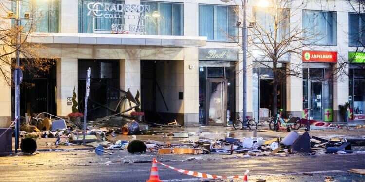 Debris lay on the street after a huge fish tank burst at the Seal Life Aquarium in central Berlin, Germany, Friday, Dec. 16, 2022 Germany: Huge Berlin aquarium bursts, releases flood of fish