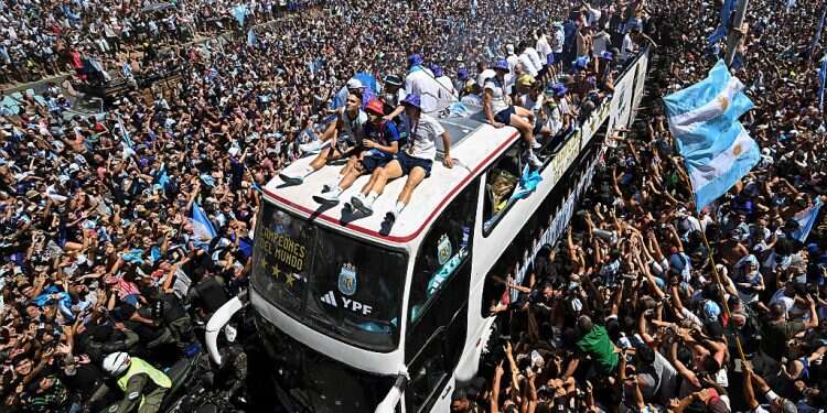 Fans of Argentina cheer as the team parades on board a bus after winning the Qatar 2022 World Cup tournament in Buenos Aires, Argentina, Dec. 20, 2022 Argentina players airlifted as World Cup celebrations get out of control