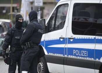 Police officers stand by a searched property in Frankfurt during a raid against so-called 'Reich citizens' in Frankfurt, Germany, Dec. 7, 2022 25 arrested in Germany on suspicion of planning armed coup