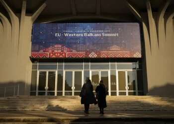 People walk outside the venue of the EU Western Balkans Summit, in Tirana, Albania, Dec. 5, 2022 EU, Western Balkans to boost partnership amid Ukraine war